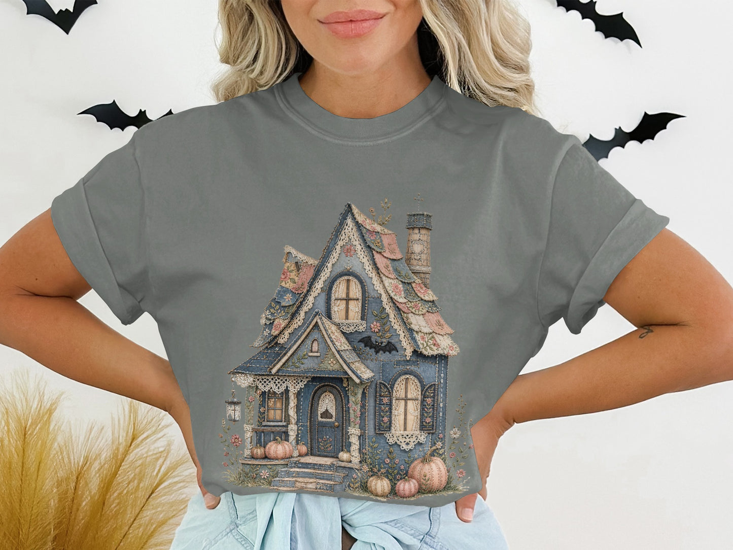 Gray t-shirt with illustration of a blue, decorative house and pumpkins.