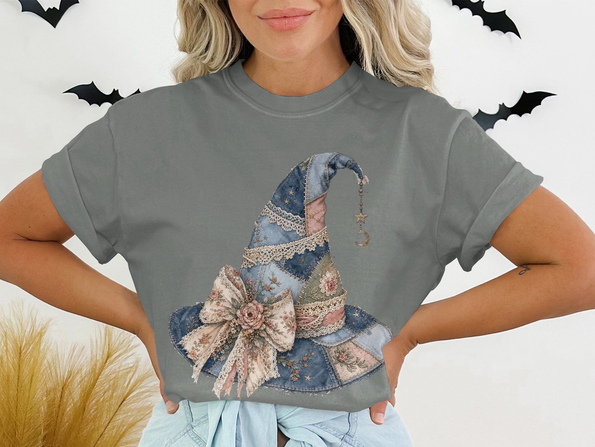 Gray t-shirt with patchwork witch hat with floral bow and moon charm graphic.