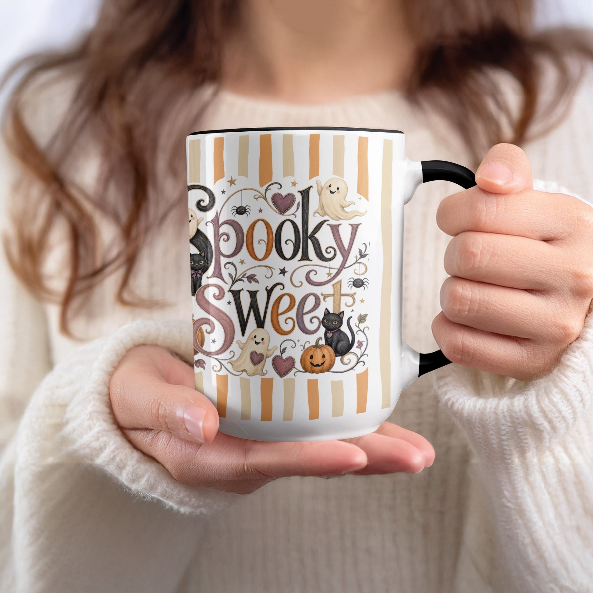 Mug with "Spooky Sweet" text, ghosts, cats, pumpkin, and spiders on striped background.