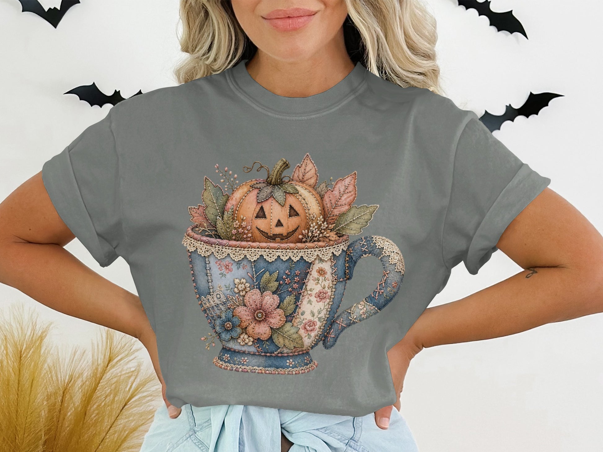 Jack-o'-lantern in a patchwork teacup with floral and leaf accents