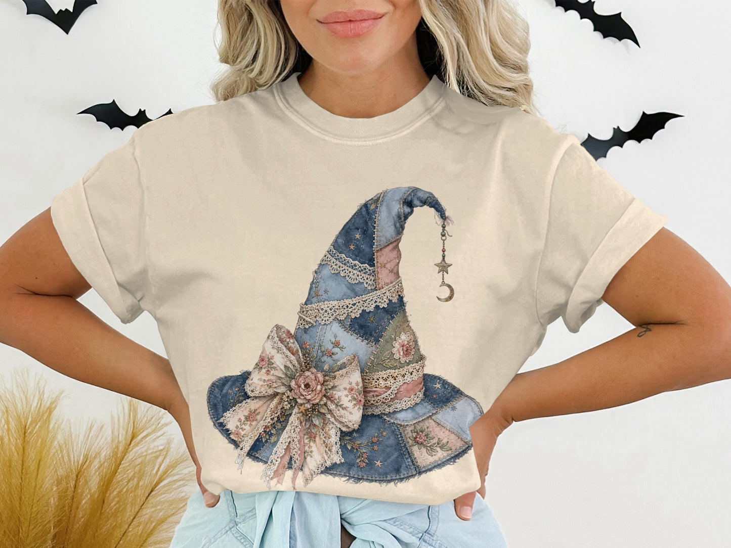 T-shirt with a quilted witch hat graphic featuring a floral bow and moon charm.