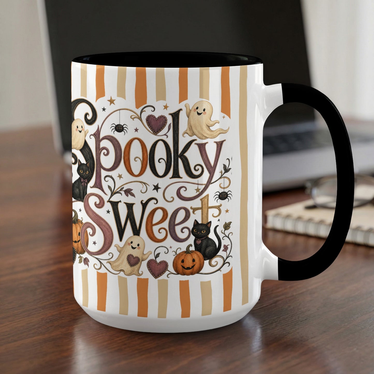 Mug with "Spooky Sweet" text, ghosts, black cats, pumpkins, and spiders on striped background.