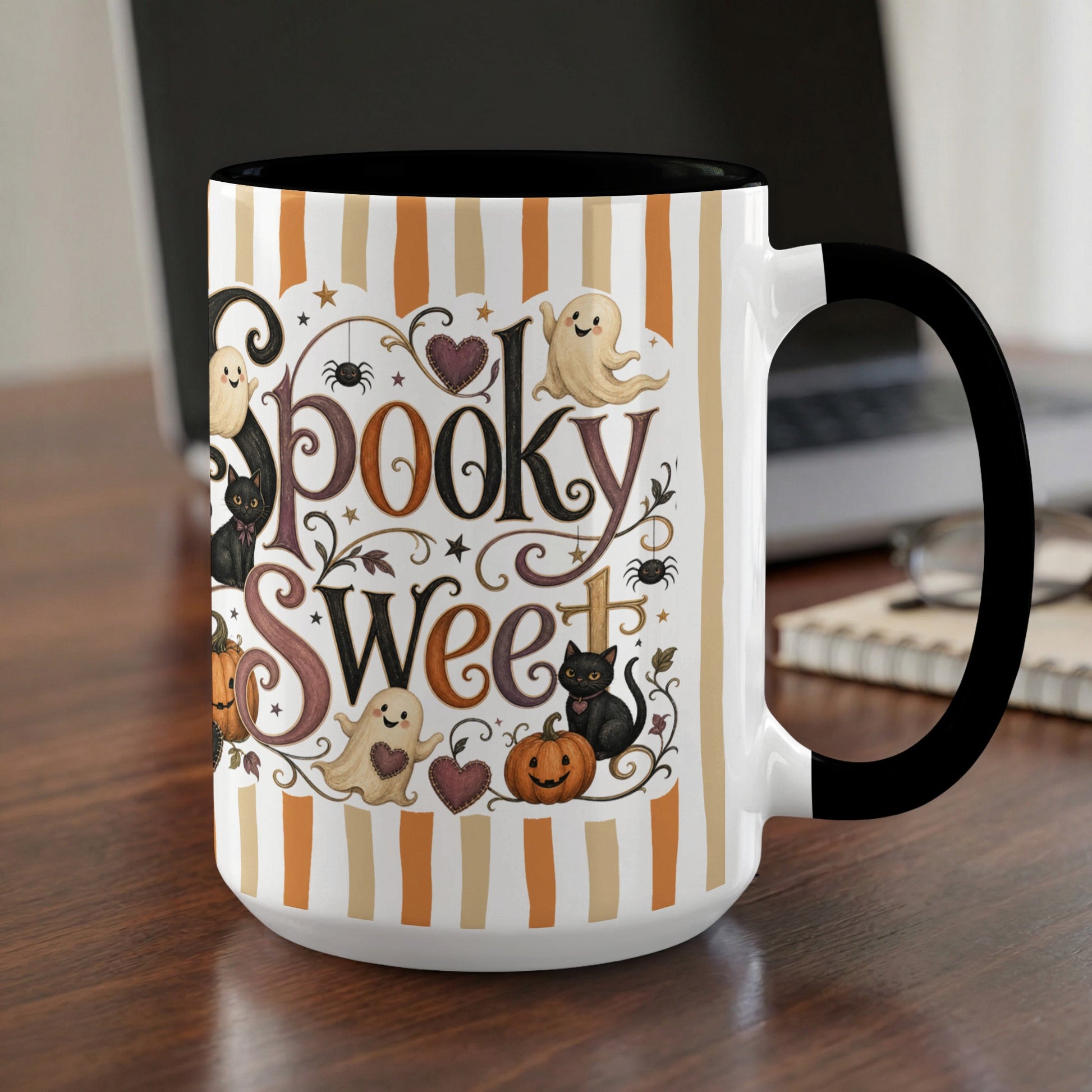 Mug with "Spooky Sweet" text, ghosts, black cats, pumpkins, and spiders on striped background.