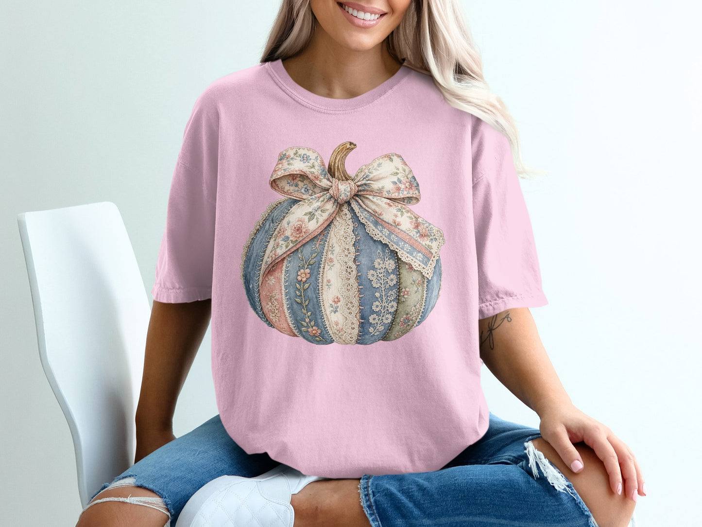 Pink t-shirt with a floral fabric pumpkin graphic with lace and bow.