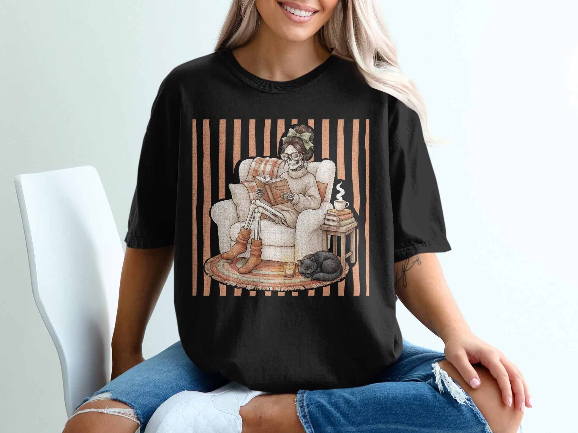 Skeleton reading "Autumn Tales" in armchair with cat, candle, and book stack.