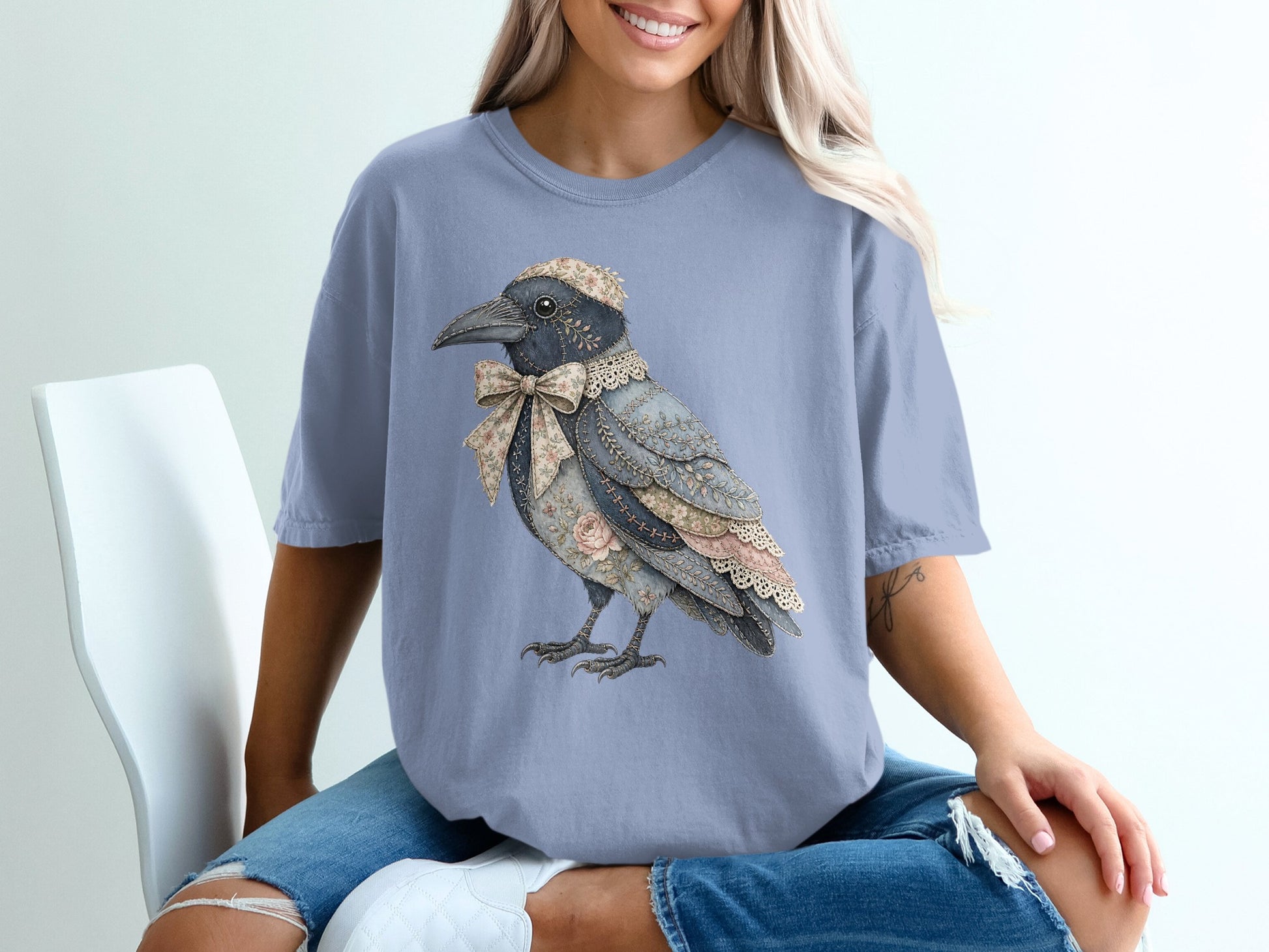 T-shirt with a collage-style crow wearing a floral bow and cap.