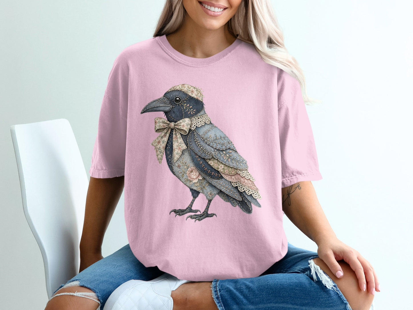 Pink t-shirt featuring a crow illustration with floral fabric and lace accents.