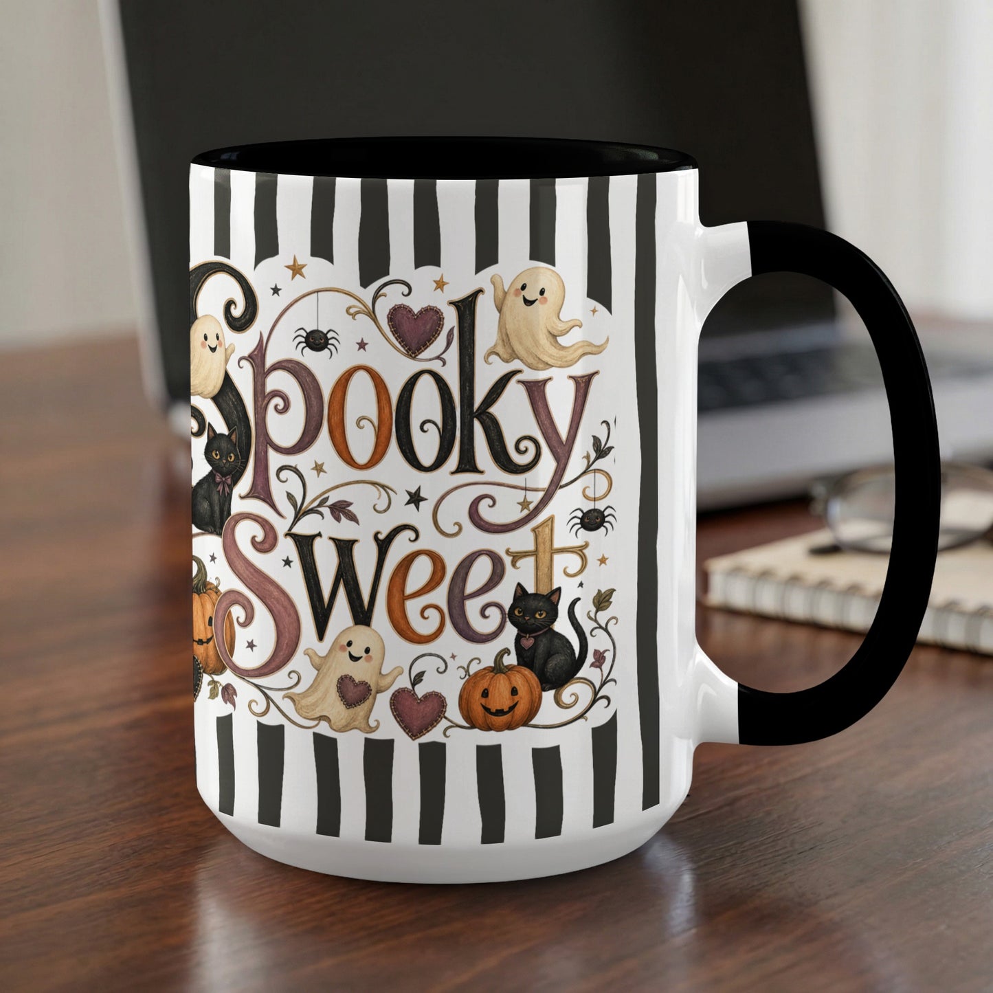 Mug with "Spooky Sweet" text, ghosts, black cats, pumpkins, spiders, and black and white stripes.