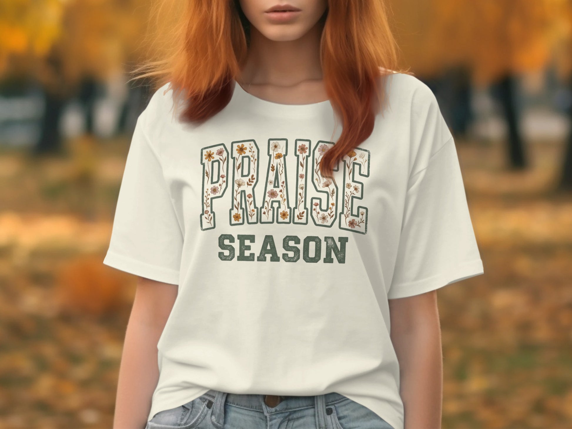 White t-shirt with "PRAISE SEASON" text, adorned with floral elements.