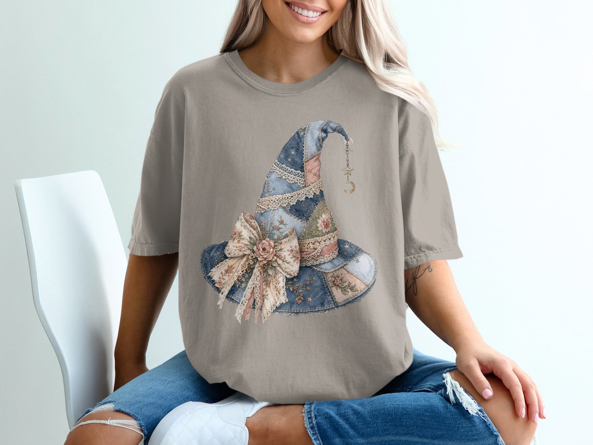 T-shirt with a quilted witch hat design featuring a floral bow and celestial charms.