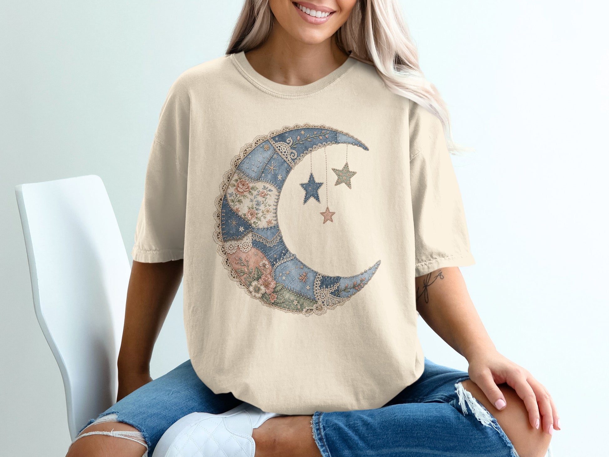 Crewneck t-shirt with crescent moon and stars graphic in patchwork style.