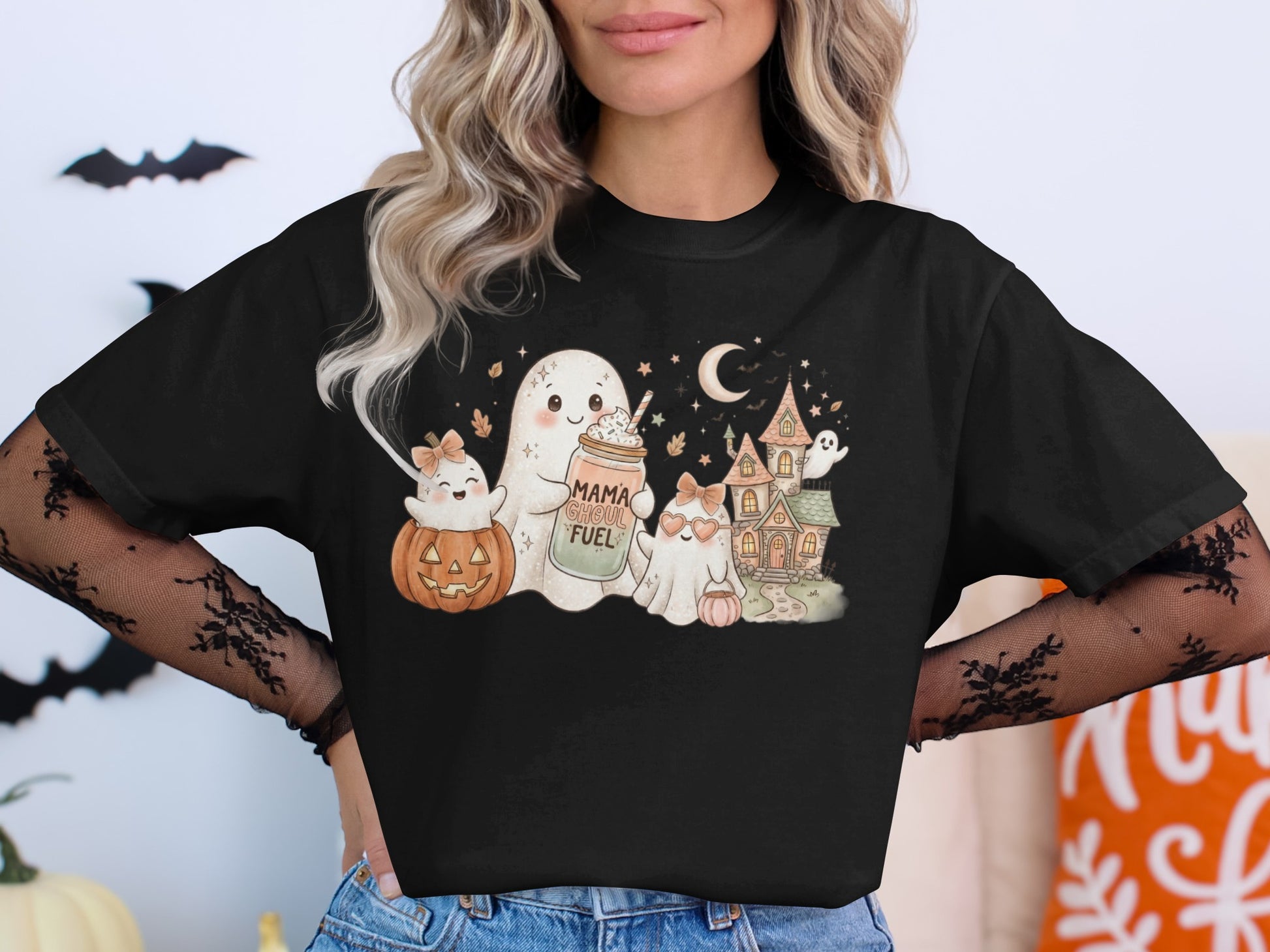 Cute ghosts and Halloween scene with text "Mama Ghoul Fuel" on shirt.