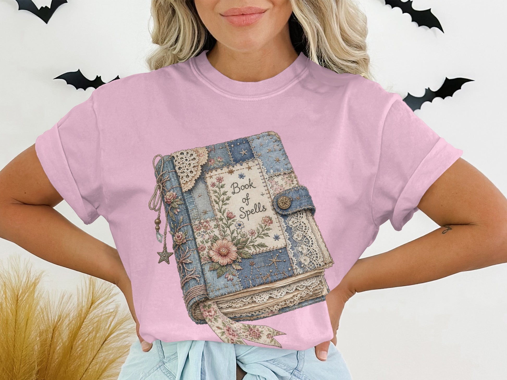 Text graphic of a vintage "Book of Spells" with floral and lace accents.
