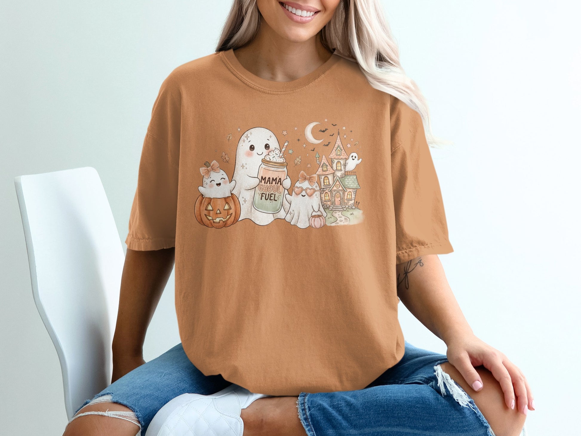 Orange t-shirt with Halloween ghosts, pumpkin, haunted house, and "Mama Ghoul Fuel" text.