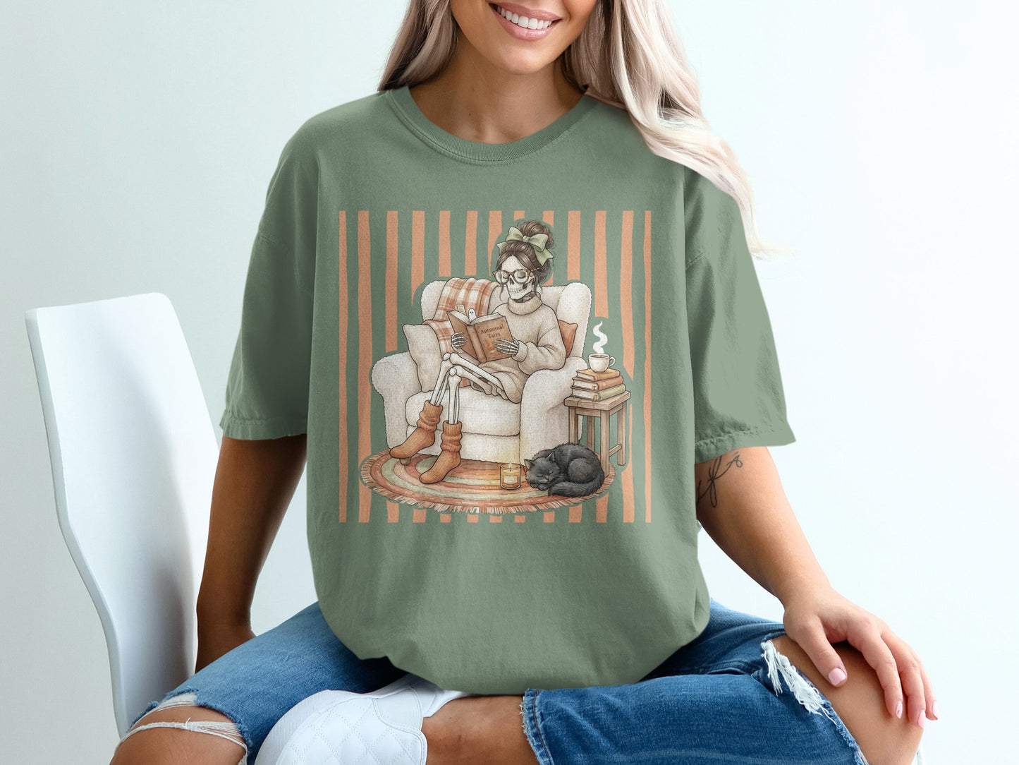 Skeleton reading a book in an armchair with a sleeping cat and a cup of coffee.