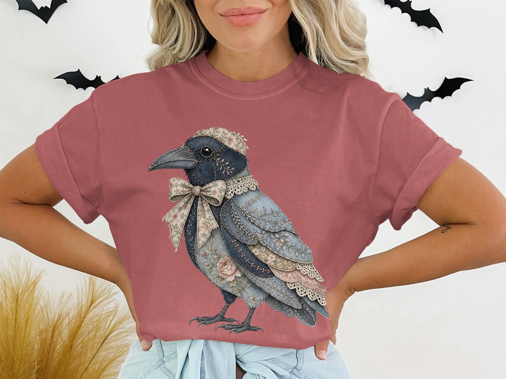 T-shirt with a detailed crow graphic wearing a floral bow and lace collar.