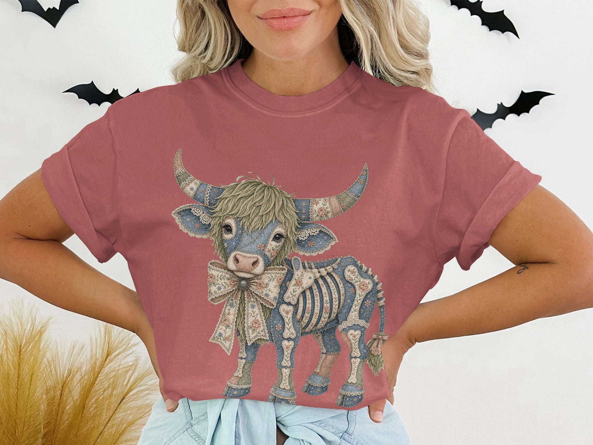 Vintage-style bovine skeleton with floral patterns and a bow.