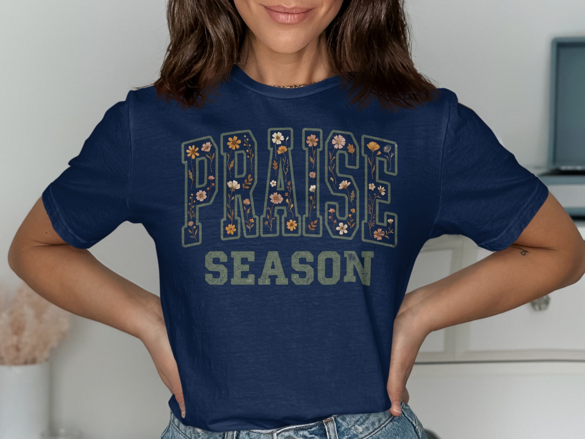Navy t-shirt with "PRAISE SEASON" text with floral accents.