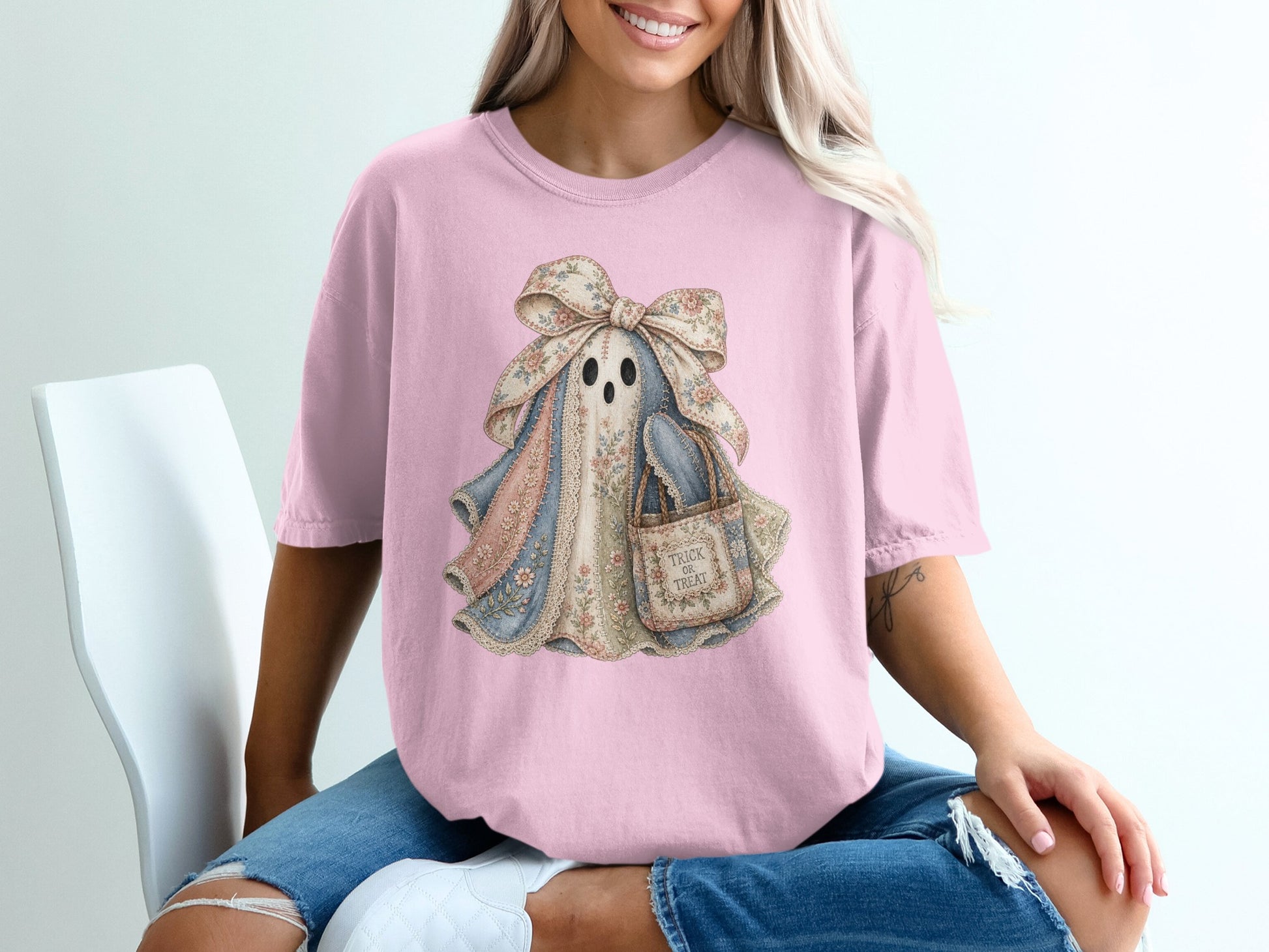 Pink t-shirt with a vintage ghost graphic holding a treat bag with "Trick or Treat" text.