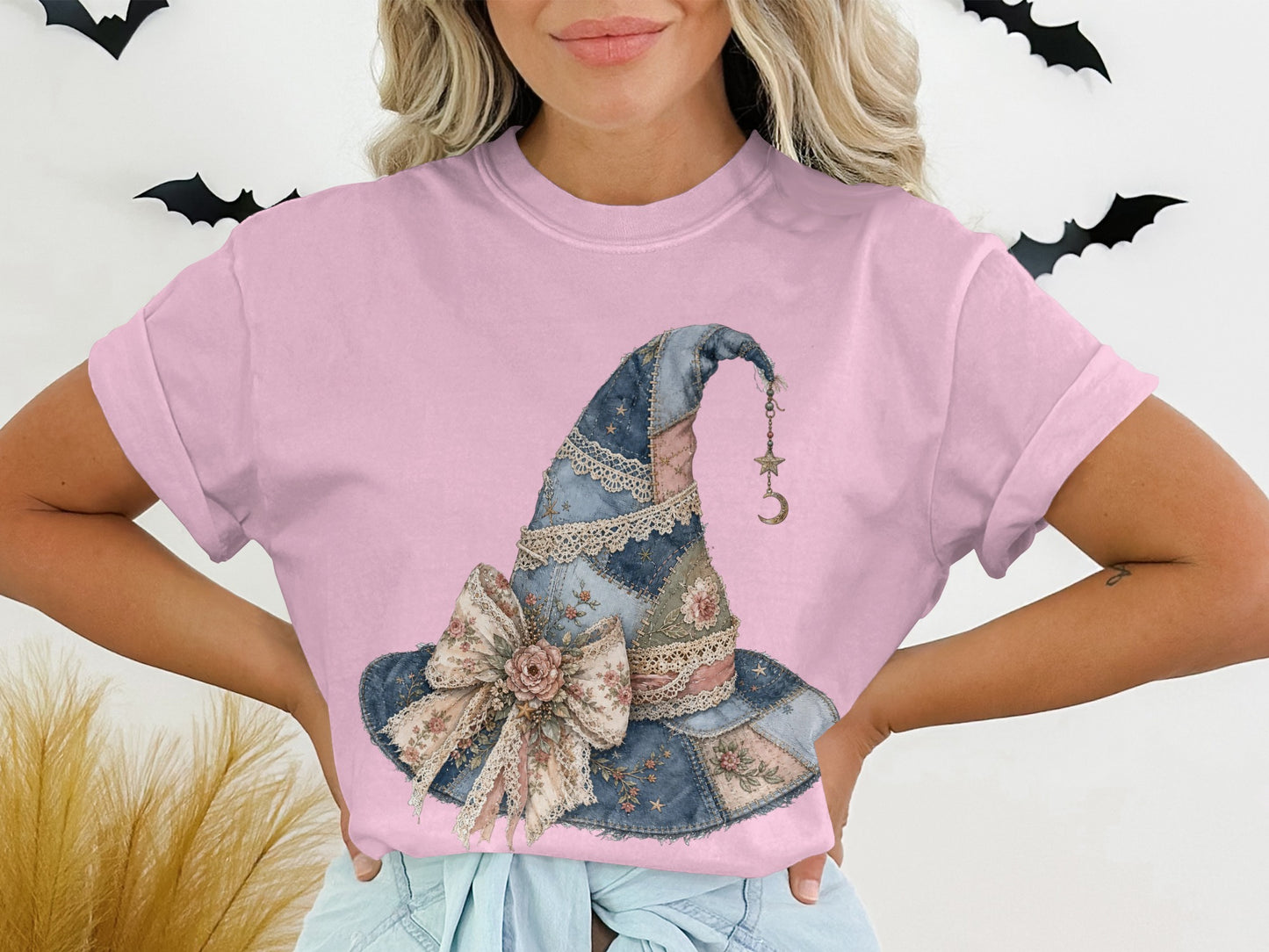 Pink t-shirt with watercolor-style patchwork witch hat graphic with bow.