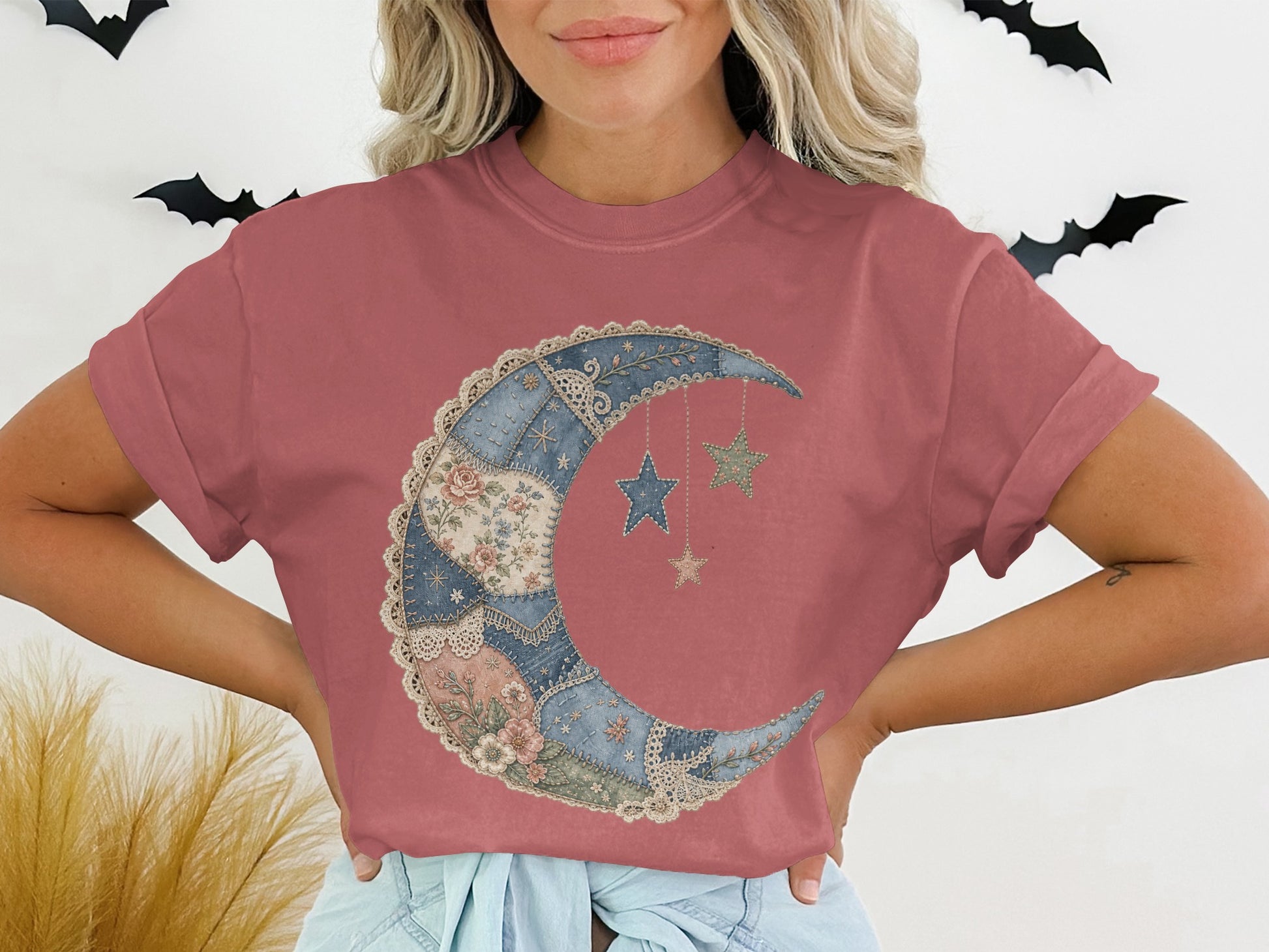 T-shirt with a patchwork crescent moon graphic and hanging stars.