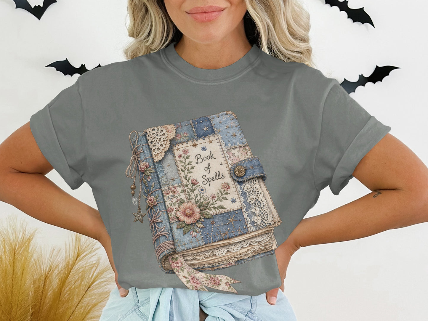 T-shirt with a book of spells graphic featuring patchwork floral and lace details.