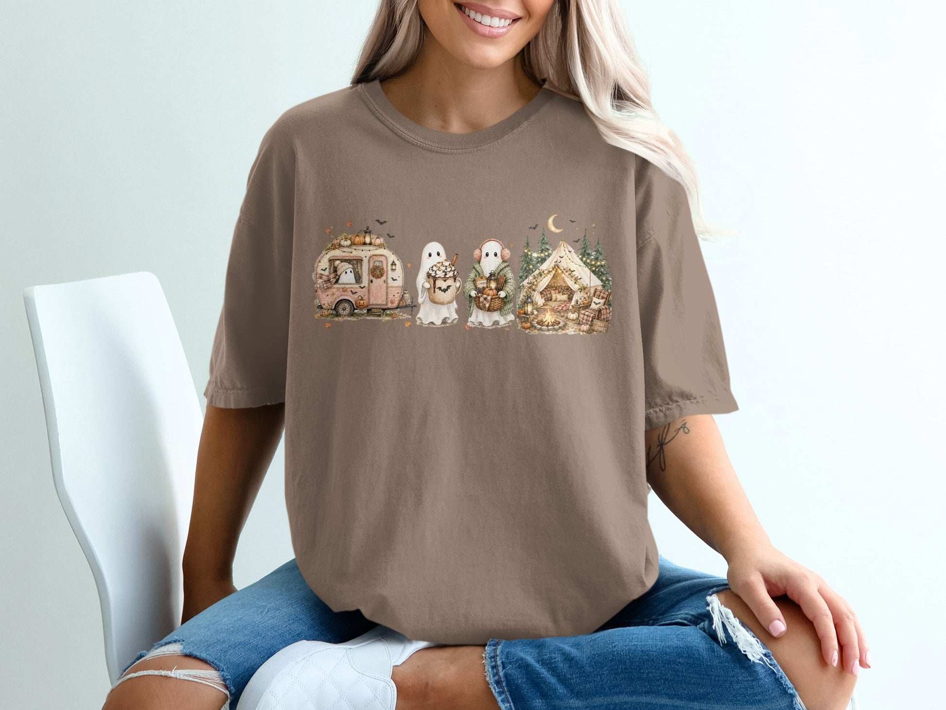 T-shirt graphic with a vintage camper, two friendly ghosts, and a tent scene with fall pumpkins.