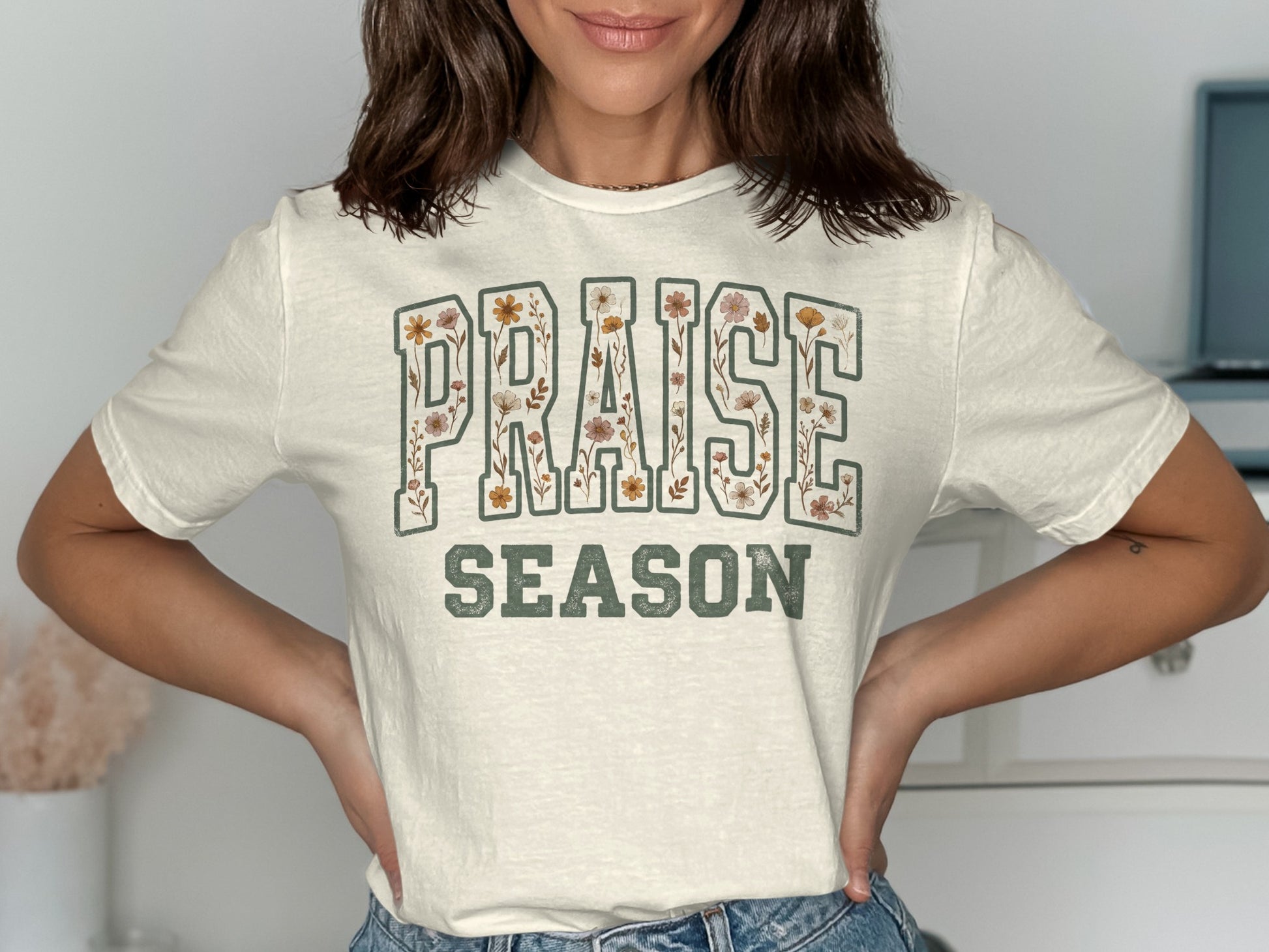 Cream t-shirt with "PRAISE SEASON" printed in floral lettering.