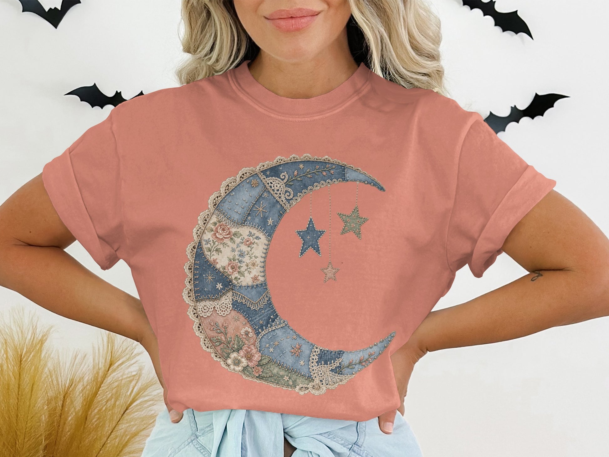 Peach t-shirt with crescent moon and star patchwork graphic.