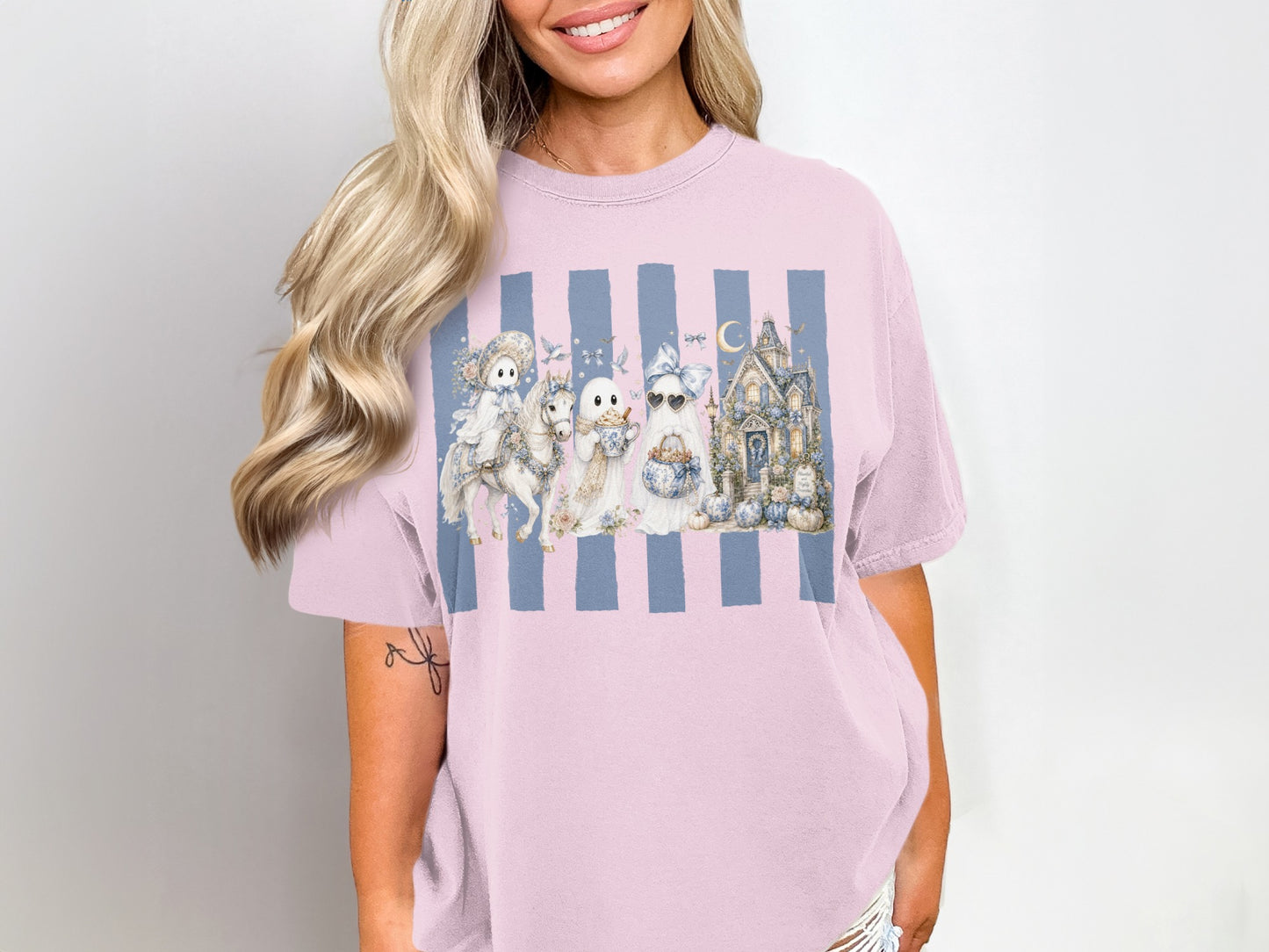 Pink t-shirt with Ghosts, unicorn, and haunted house graphic on blue stripes