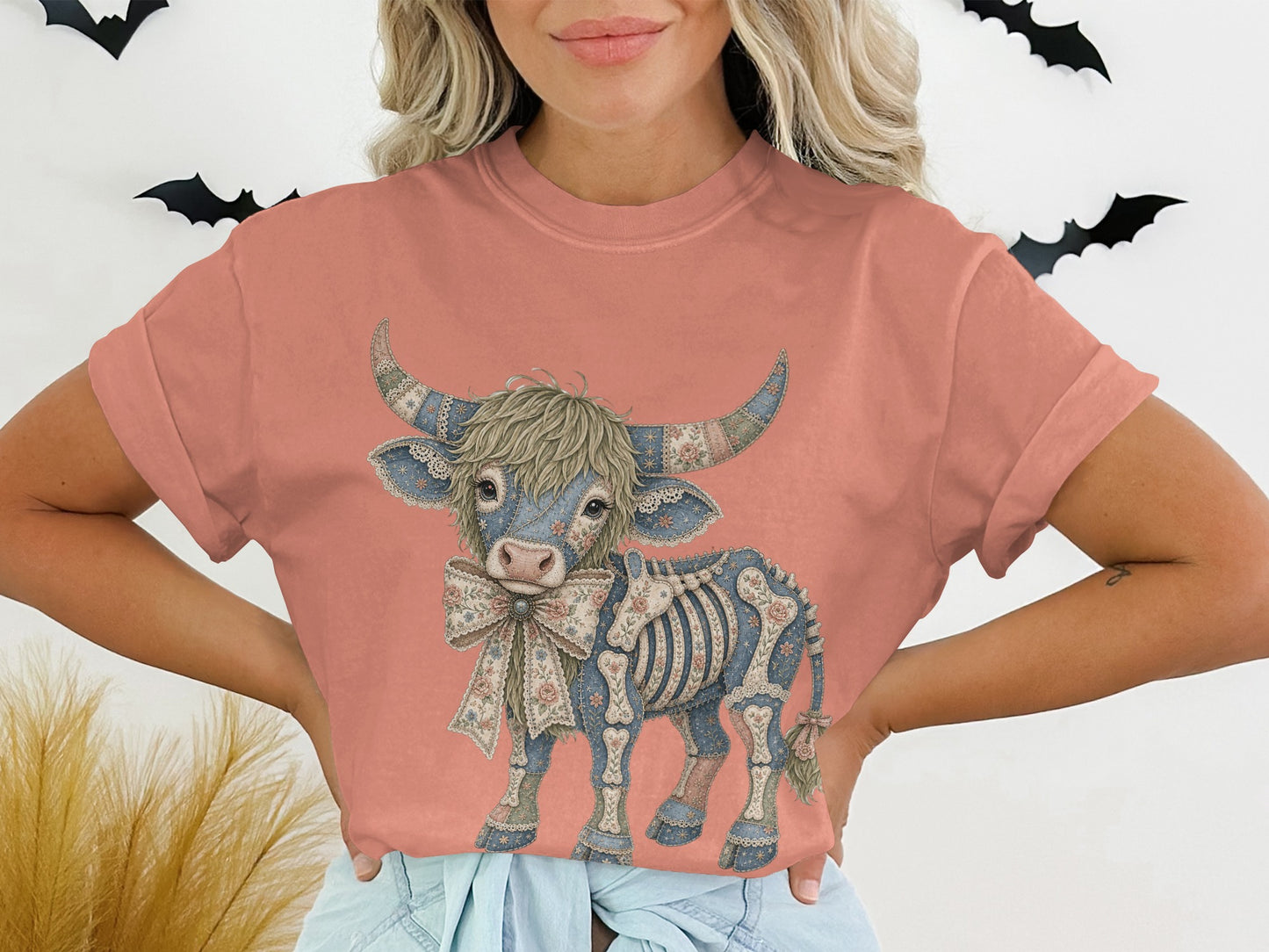 T-shirt with a patterned cow skeleton graphic and a floral bow.