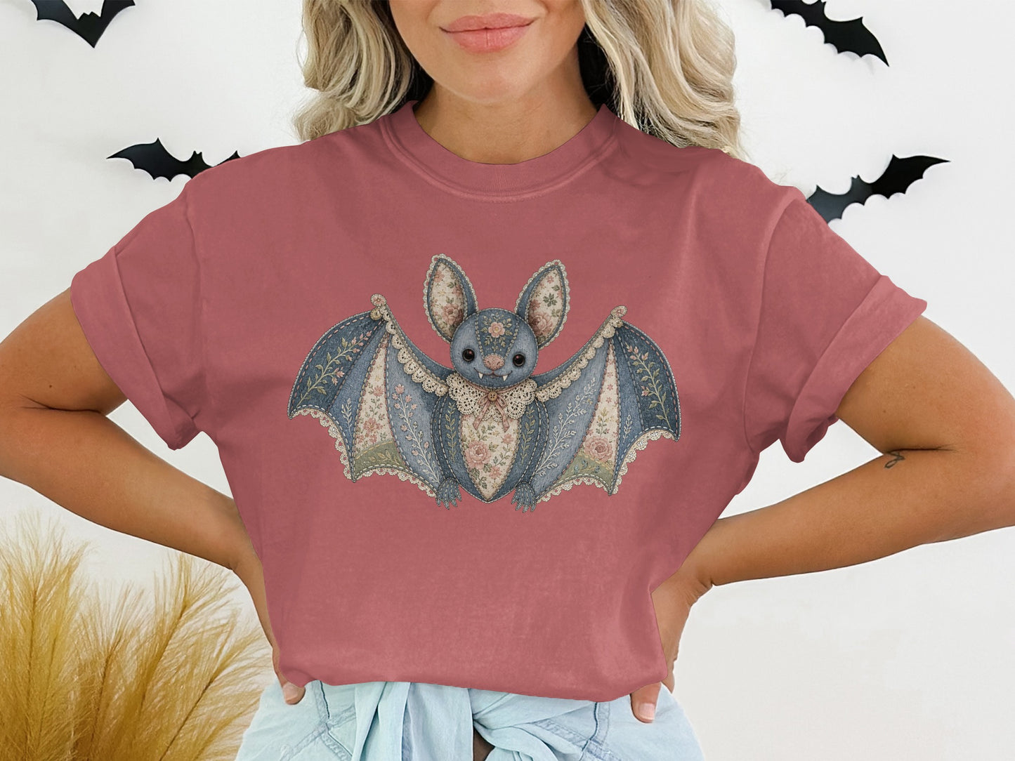 Bat graphic with floral wings on a mauve t-shirt.