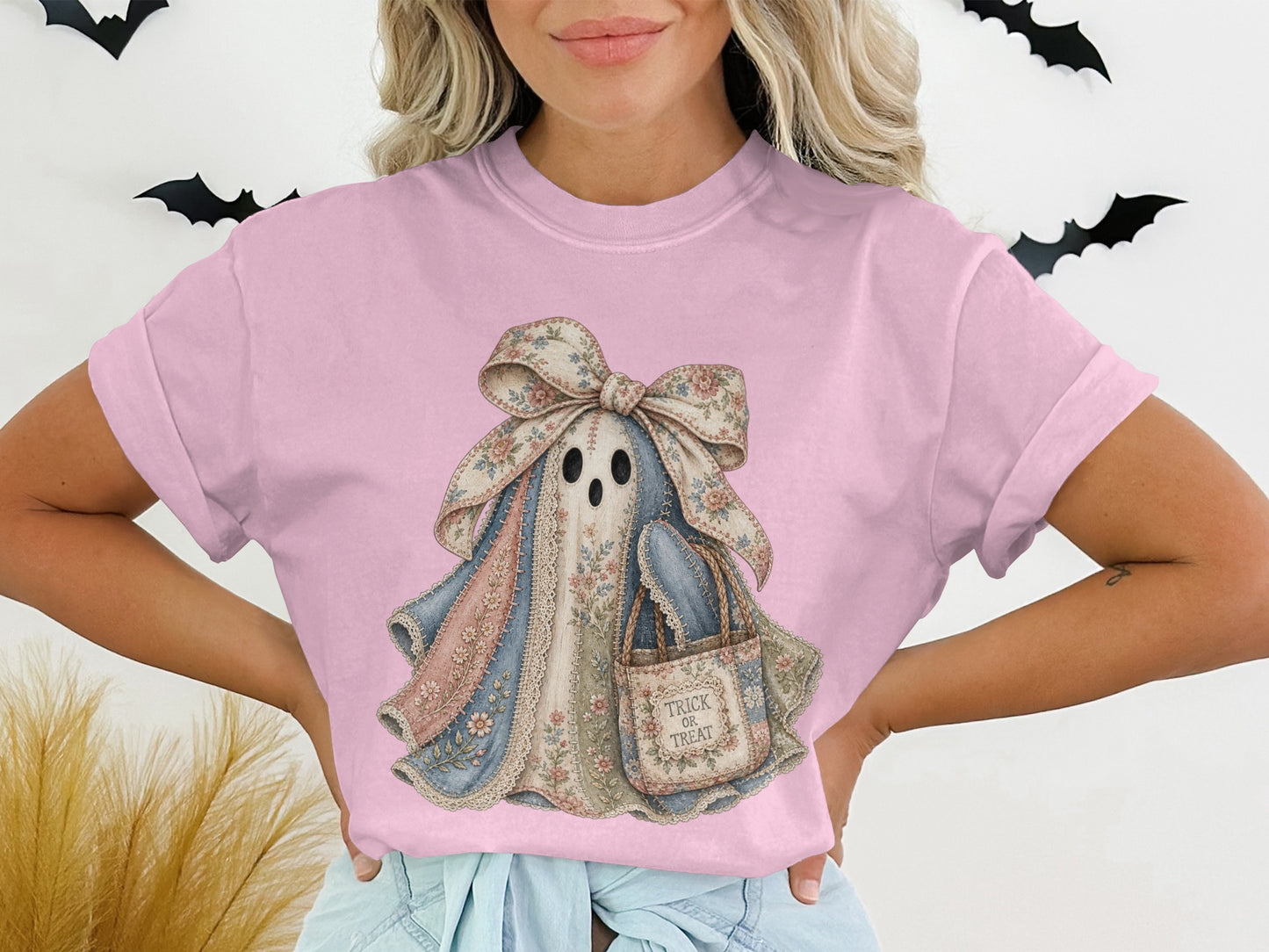 Ghost graphic on pink t-shirt with floral bow and "Trick or Treat" bag.