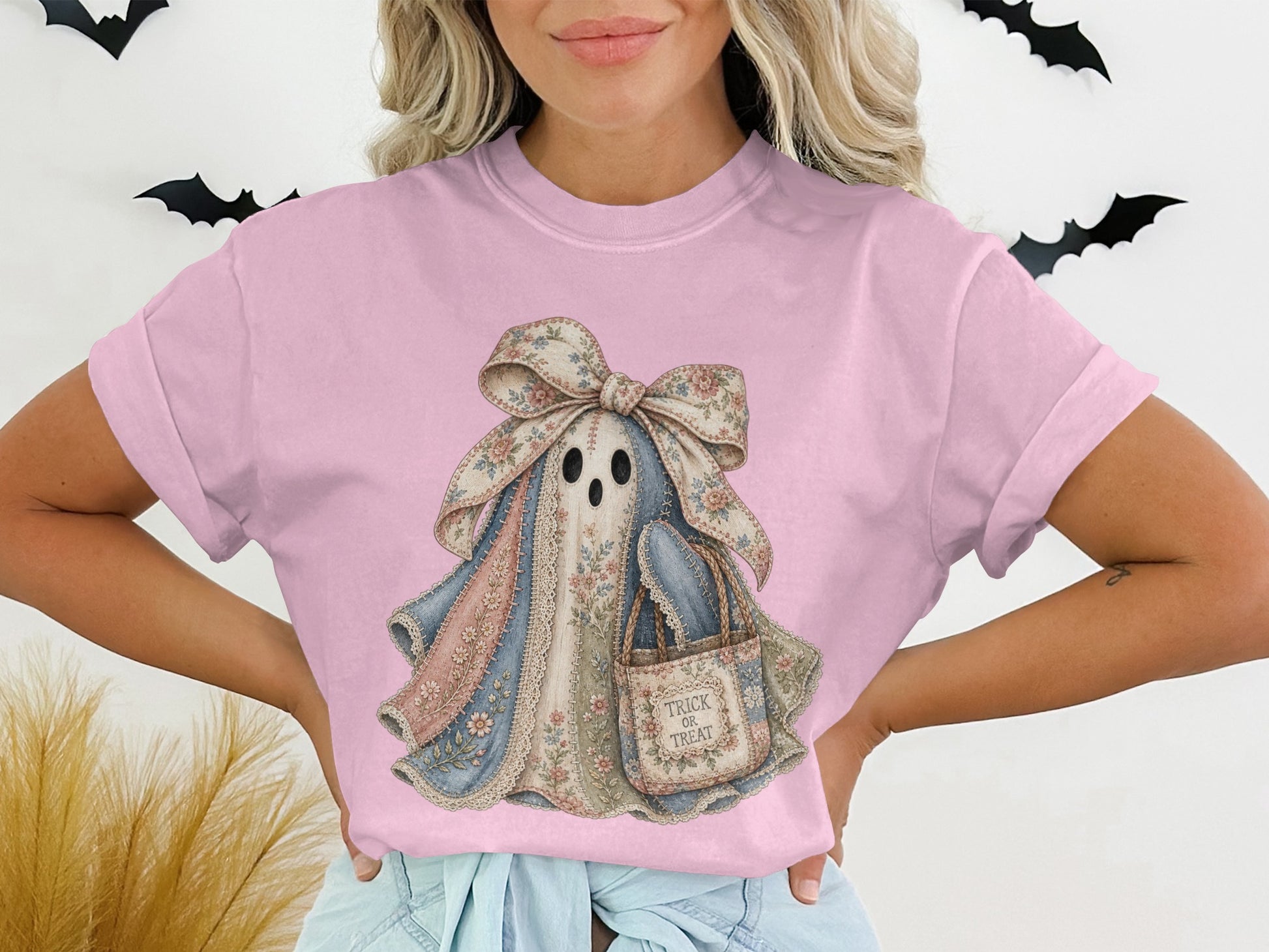 Ghost graphic on pink t-shirt with floral bow and "Trick or Treat" bag.